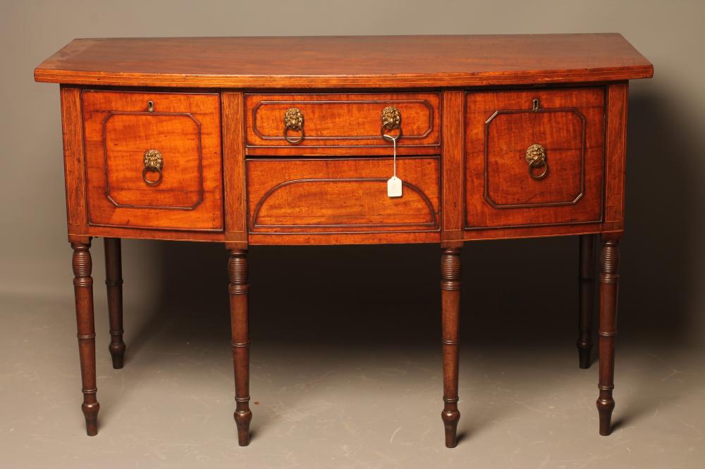 A REGENCY MAHOGANY SIDEBOARD of mildly bowed form with stringing and applied panel beading to fascia Image