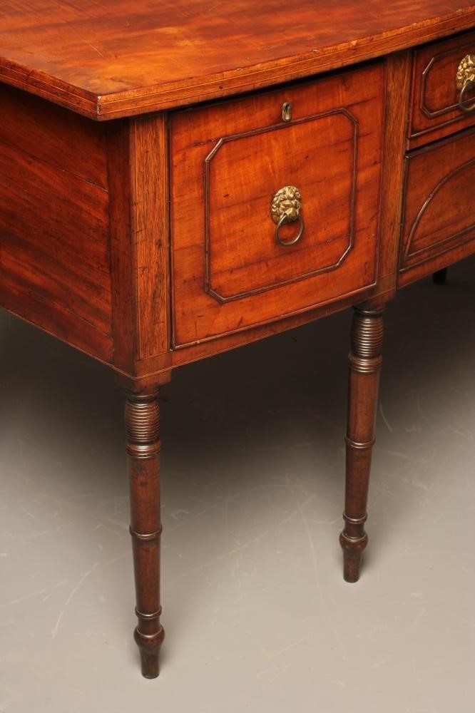 A REGENCY MAHOGANY SIDEBOARD of mildly bowed form with stringing and applied panel beading to fascia Image