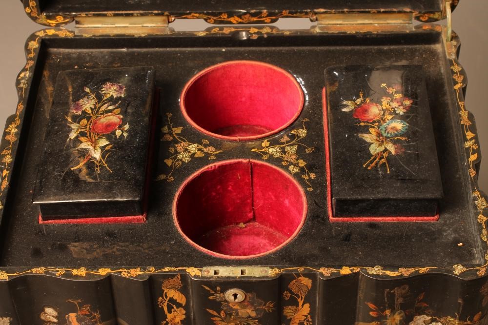 A VICTORIAN PAPIER MACHE TEAPOY of serpentine oblong form gilded with floral sprays and mother of Image