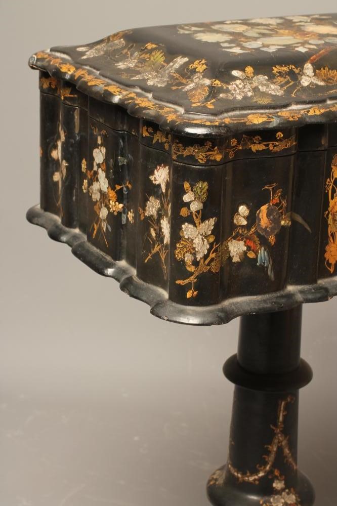 A VICTORIAN PAPIER MACHE TEAPOY of serpentine oblong form gilded with floral sprays and mother of Image