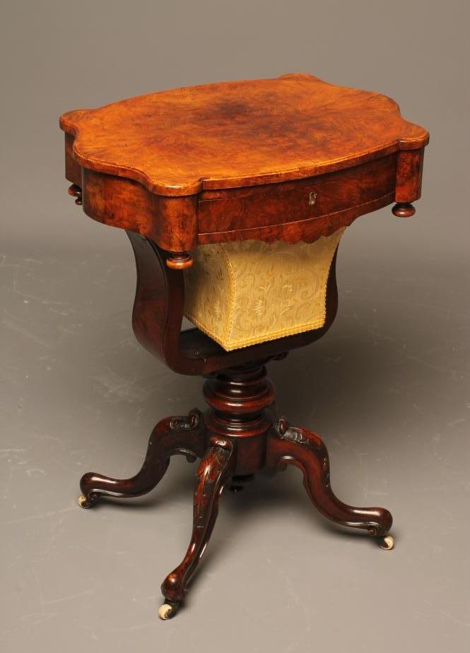 A VICTORIAN WALNUT WORK TABLE of oblong serpentine form Image