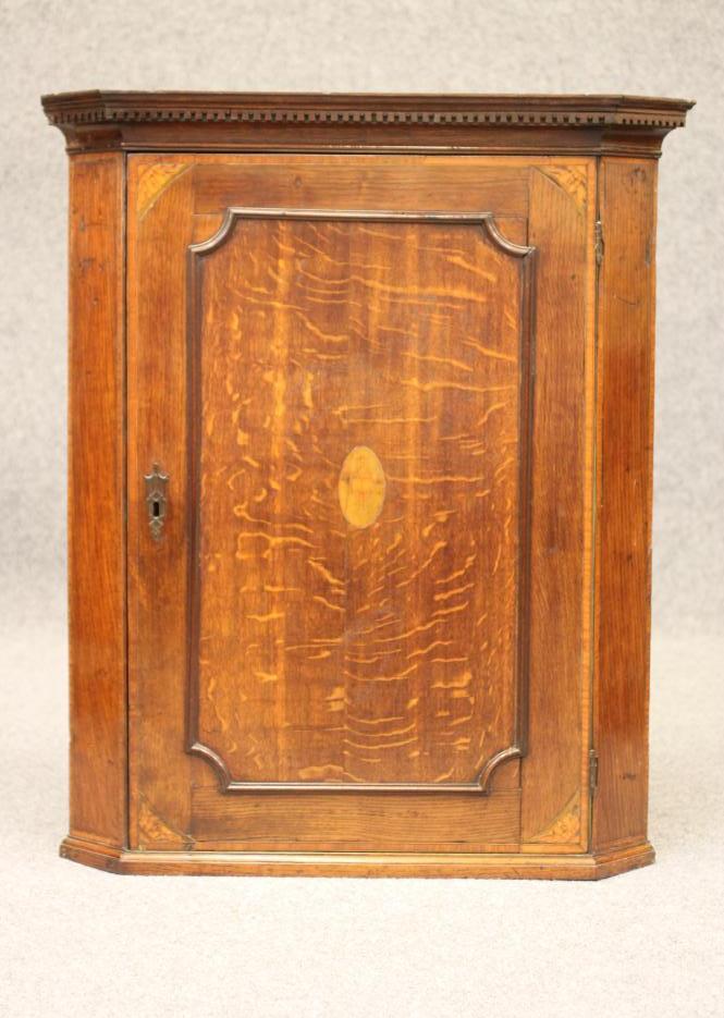 A GEORGIAN OAK AND SATINWOOD BANDED CORNER CUPBOARD Image