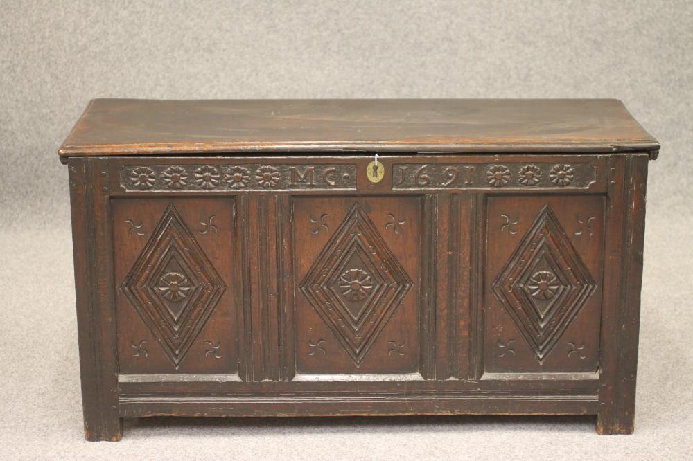 AN OAK PANELLED COFFER Image