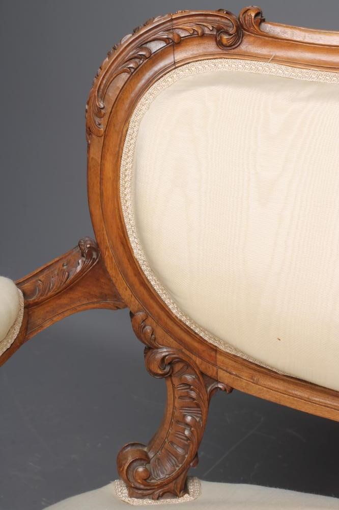 A NAPOLEON III CARVED WALNUT CANAPE upholstered in ivory silk Image