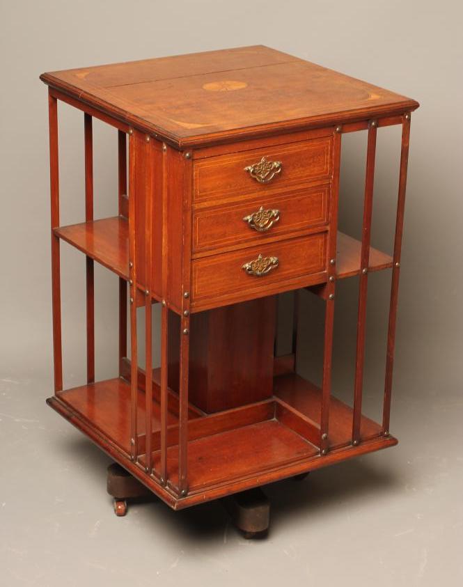 AN EDWARDIAN MAHOGANY REVOLVING BOOKCASE of square form with stringing Image