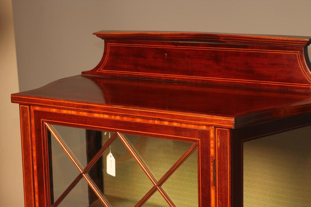 AN EDWARDIAN MAHOGANY PIER DISPLAY CABINET of canted oblong form with satinwood banding and Image