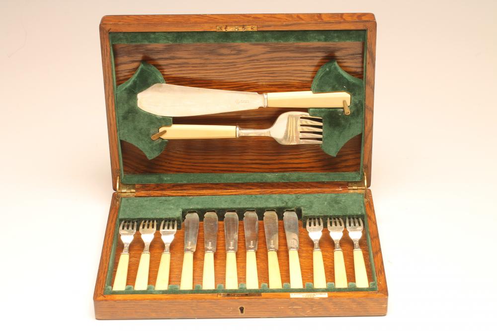 *A SET OF SIX PAIRS OF SILVER FISH KNIVES AND FORKS WITH MATCHING SERVERS Image