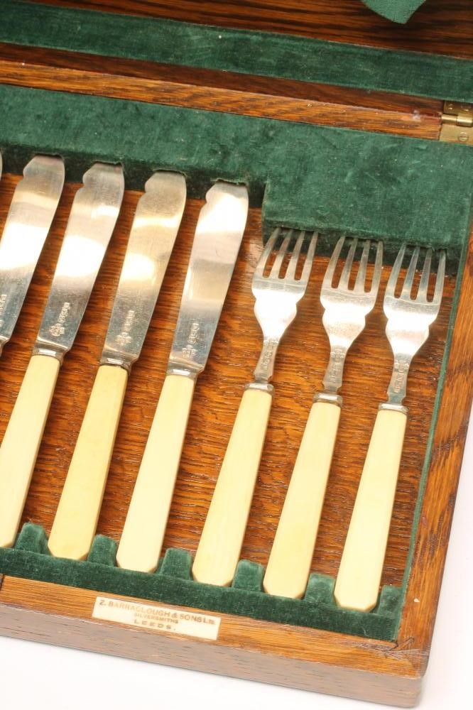 *A SET OF SIX PAIRS OF SILVER FISH KNIVES AND FORKS WITH MATCHING SERVERS Image