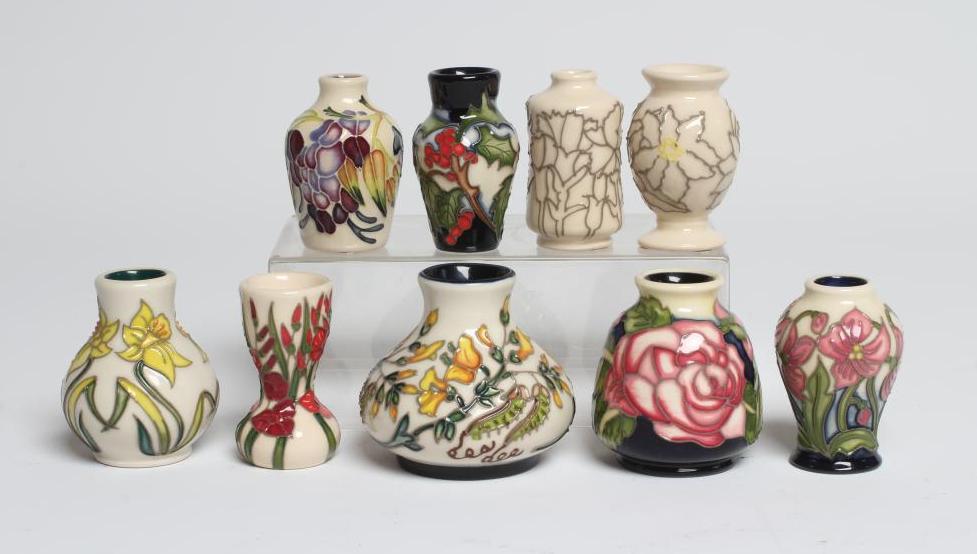 A COLLECTION OF NINE MINIATURE MOORCROFT POTTERY VASES Image