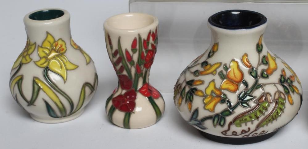 A COLLECTION OF NINE MINIATURE MOORCROFT POTTERY VASES Image