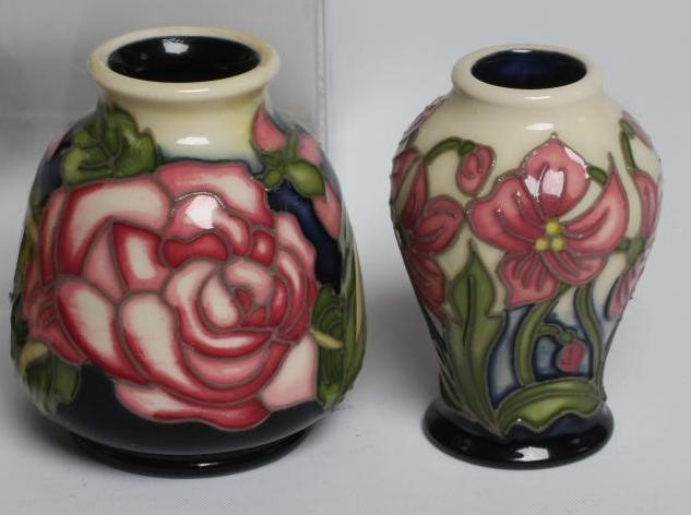 A COLLECTION OF NINE MINIATURE MOORCROFT POTTERY VASES Image