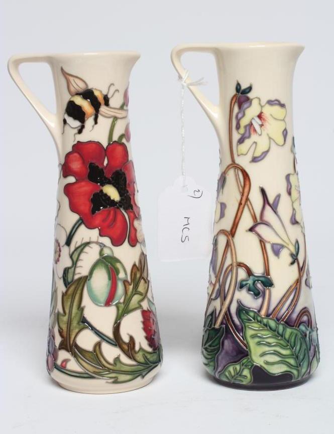 TWO MOORCROFT POTTERY EWERS of tapering cylindrical form Image