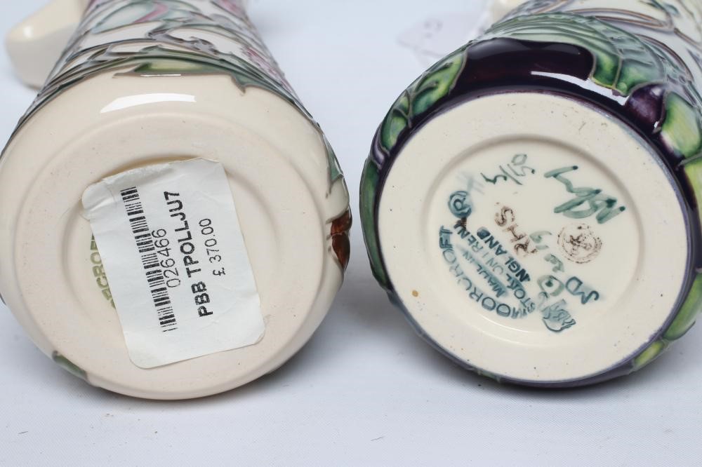 TWO MOORCROFT POTTERY EWERS of tapering cylindrical form Image