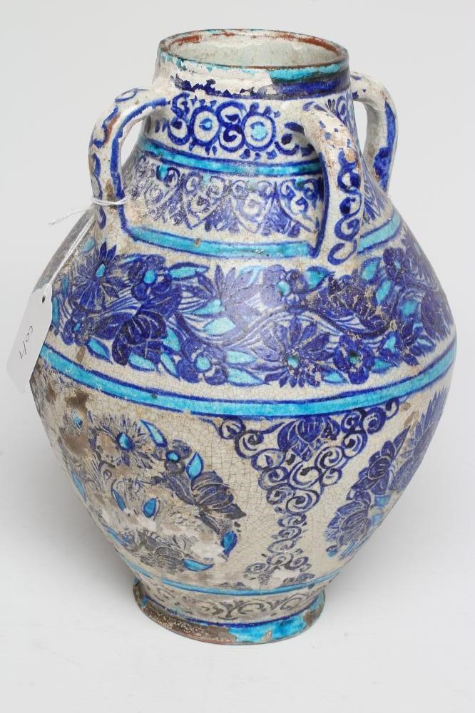 AN INDIAN MULTAN TIN GLAZED EARTHENWARE JAR of conical form with four loop handles Image