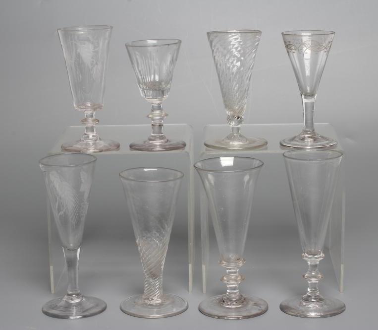 A COLLECTION OF SEVEN GLASS FLUTES Image