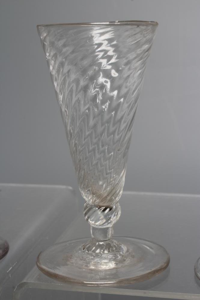A COLLECTION OF SEVEN GLASS FLUTES Image