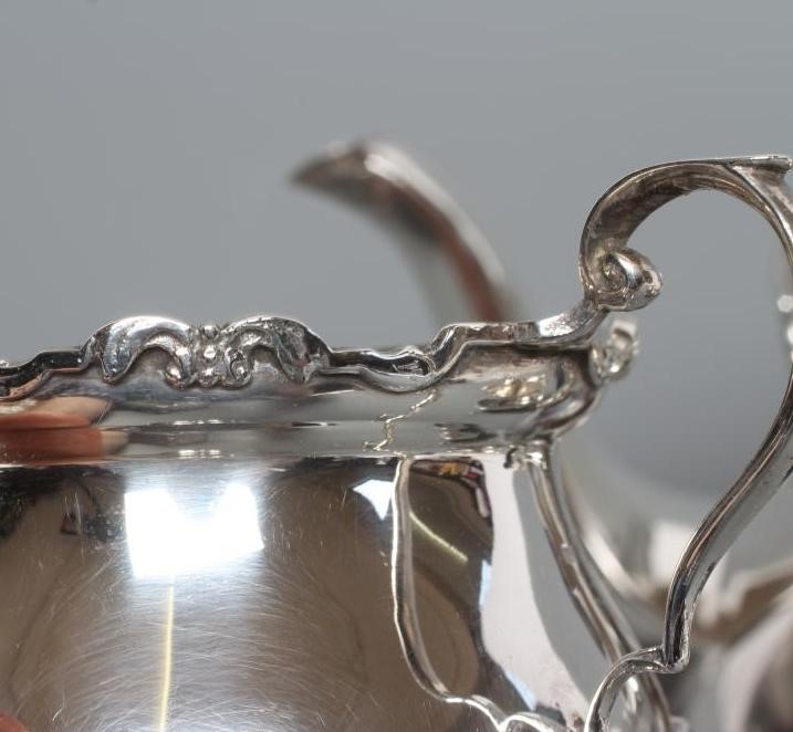 A SILVER THREE PIECE TEA SERVICE Image