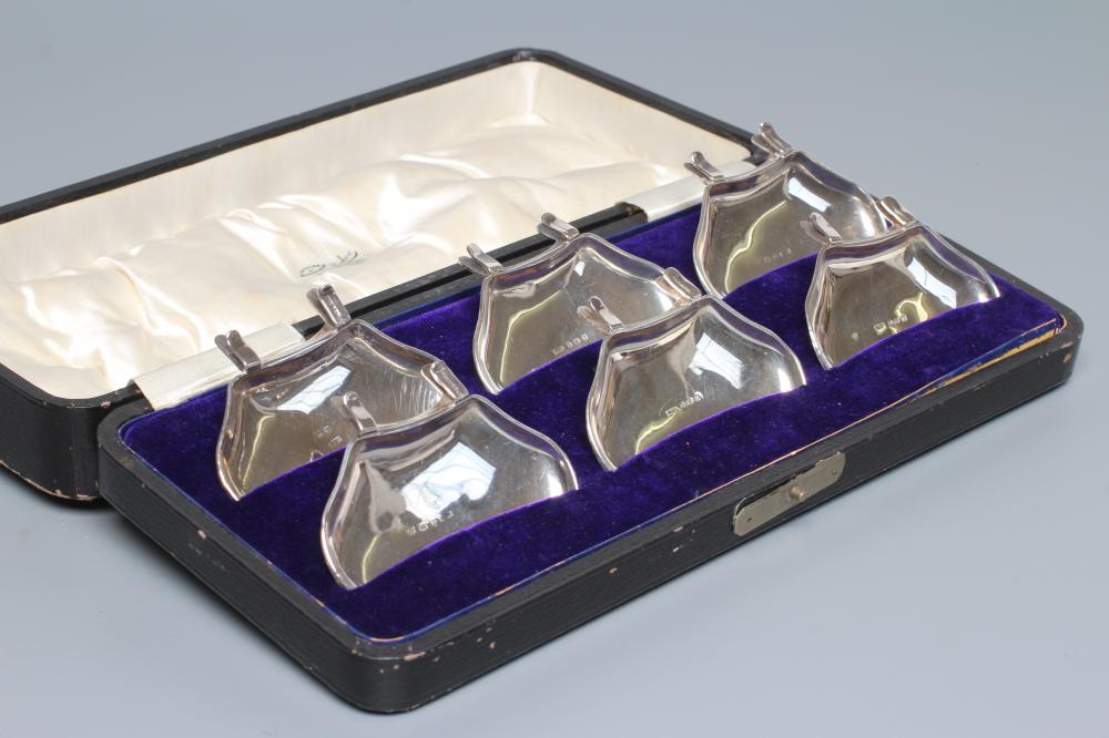 A SET OF SIX INDIVIDUAL SILVER CONDIMENT TRAYS, maker H J Cooper, Birmingham 1911, of shaped oblong Image