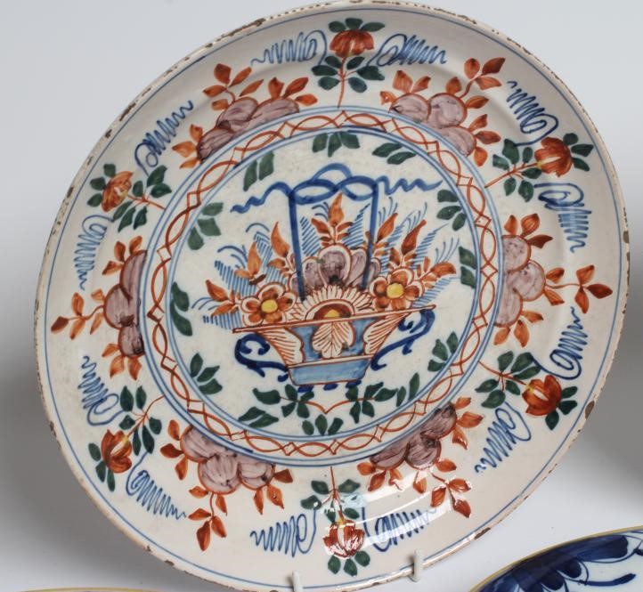A DUTCH DELFT DISH of plain circular form painted in polychrome enamels with a parrot perched upon a Image