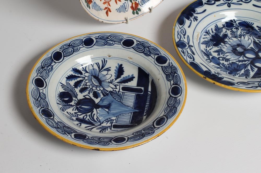 A DUTCH DELFT DISH of plain circular form painted in polychrome enamels with a parrot perched upon a Image