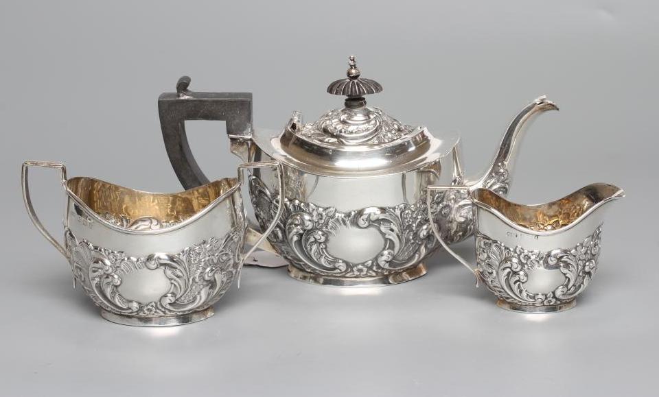 A BACHELOR'S EDWARDIAN SILVER COMPOSITE THREE PIECE TEA SERVICE Image