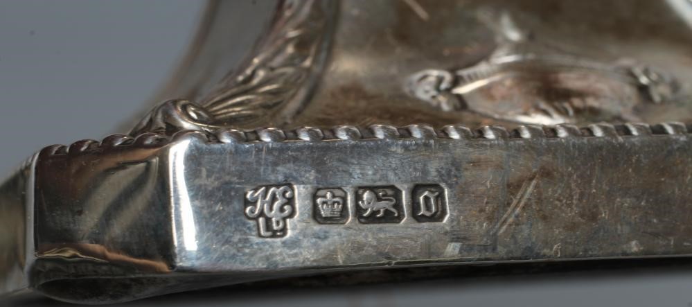 A COMPOSITE PAIR OF EDWARDIAN SILVER DWARF CANDLESTICKS Image