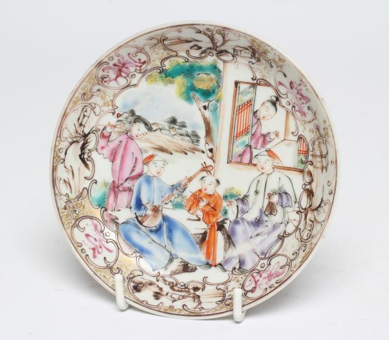 A CHINESE PORCELAIN SAUCER centrally painted in coloured enamels with a boy seated at a window Image