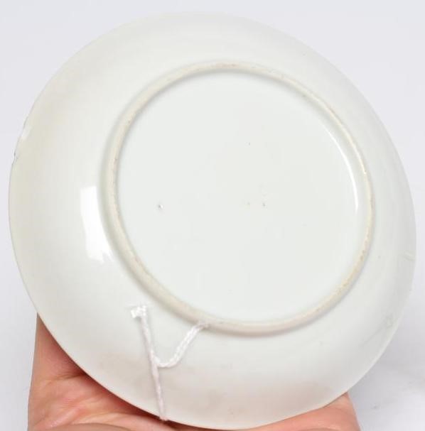 A CHINESE PORCELAIN SAUCER centrally painted in coloured enamels with a boy seated at a window Image