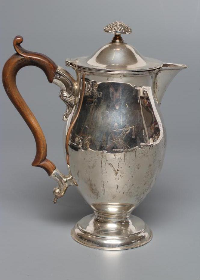 A LATE VICTORIAN SILVER HOT WATER JUG Image