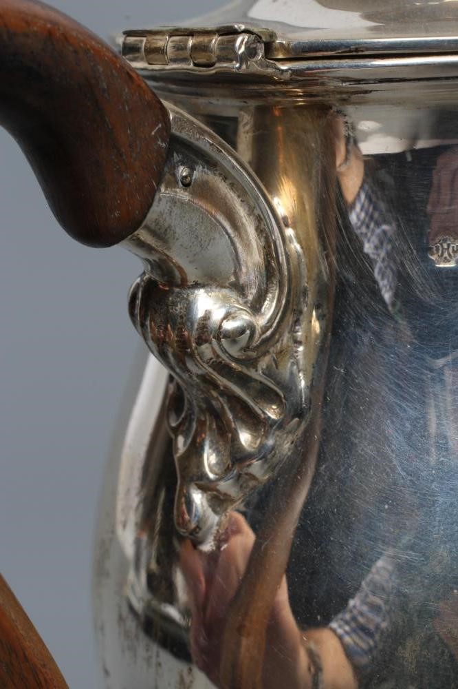 A LATE VICTORIAN SILVER HOT WATER JUG Image