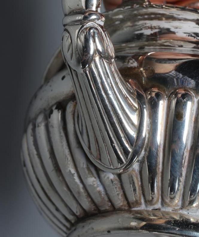 A LATE GEORGE III SILVER MILK JUG, maker Burwash and Sibley, London 1809, of semi-fluted squat Image