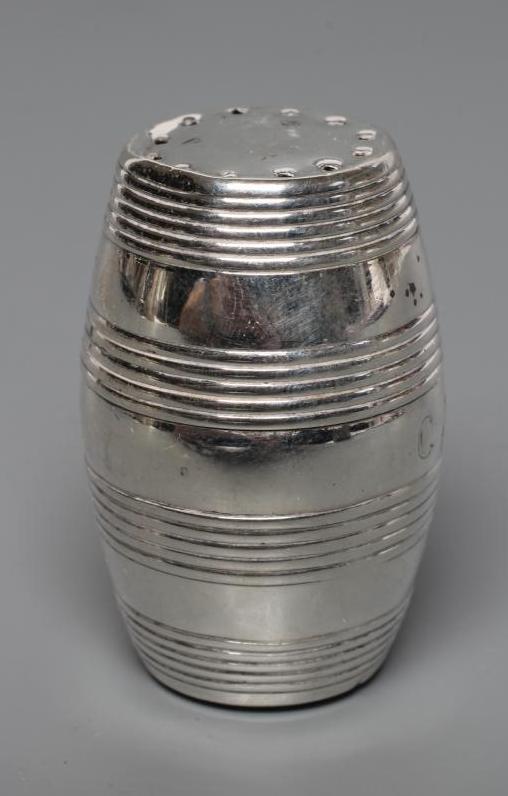 A LATE GEORGE III SILVER CAYENNE PEPPER CASTER Image