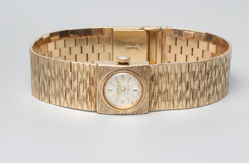 A LADY'S 9CT GOLD REALM WRISTWATCH Image