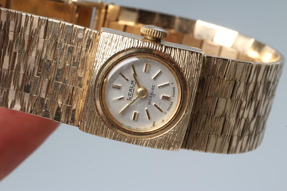 A LADY'S 9CT GOLD REALM WRISTWATCH Image