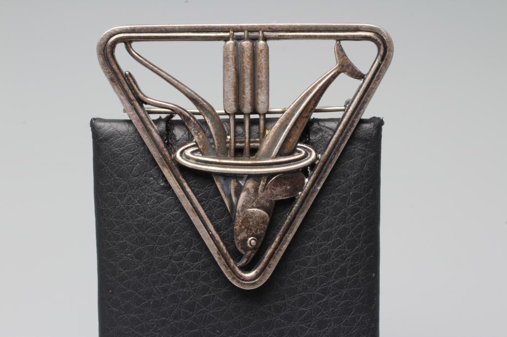A GEORG JENSEN SILVER TRIANGULAR BROOCH designed by Arno Malinowski, cast as a dolphin and reeds, Image
