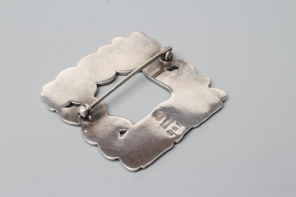 A GEORG JENSEN SILVER SQUARE BROOCH designed by Arno Malinowski with a recumbent deer and squirrel, Image