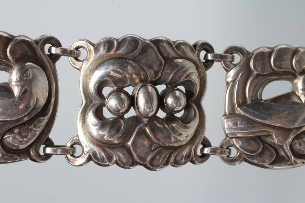 A GEORG JENSEN SILVER BRACELET designed by Jensen with shaped links cast and pierced with doves Image