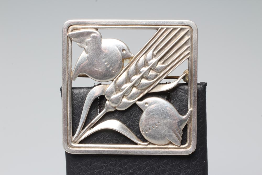A GEORG JENSEN SILVER SQUARE BROOCH designed by Arno Malinowski as two birds with a wheat ear, Image