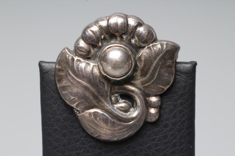 A GEORG JENSEN SILVER BROOCH cast as a stylised flower with three leaves, stamped and numbered 71 Image