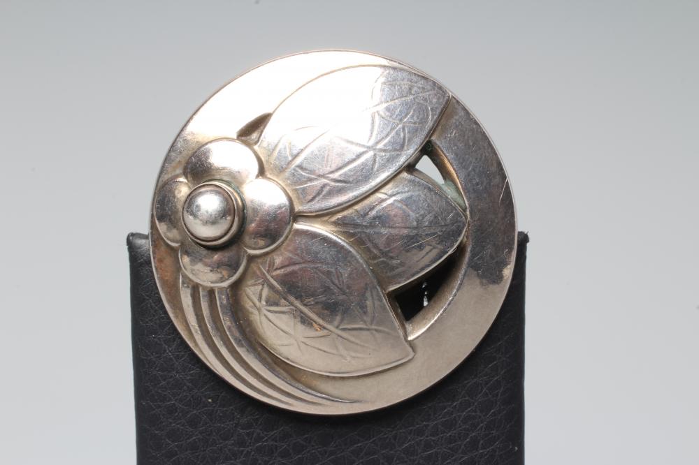 A GEORG JENSEN SILVER BROOCH of circular domed form cast and pierced with a stylised flowerhead with Image