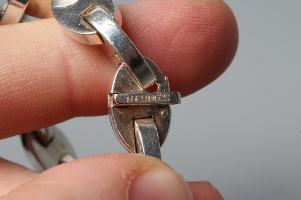 AN HERMES SILVER NECKLACE, the solid oval links with bar clasp, stamped HERMES, 925 and three other Image