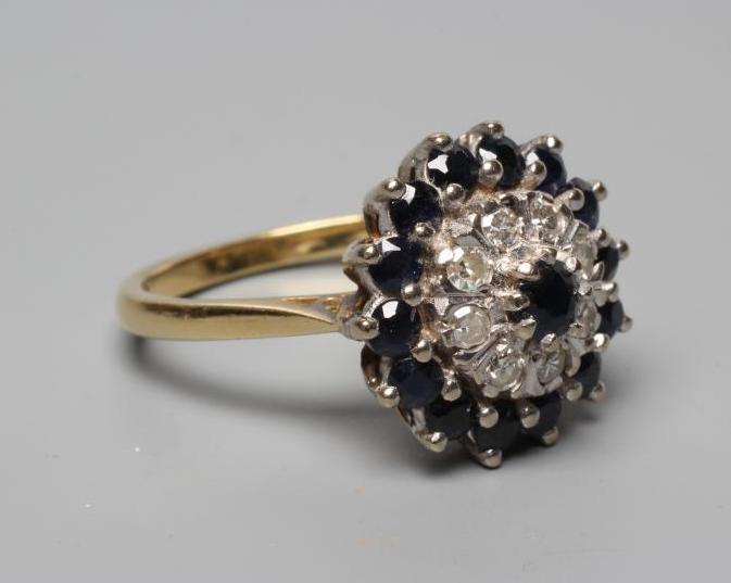 A SAPPHIRE AND DIAMOND CLUSTER RING Image