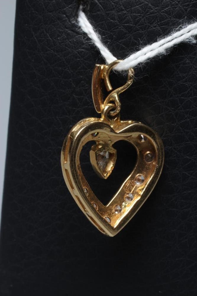 A DIAMOND HEART PENDANT, the thirteen mix cut stones point set to an open border centred by a single Image