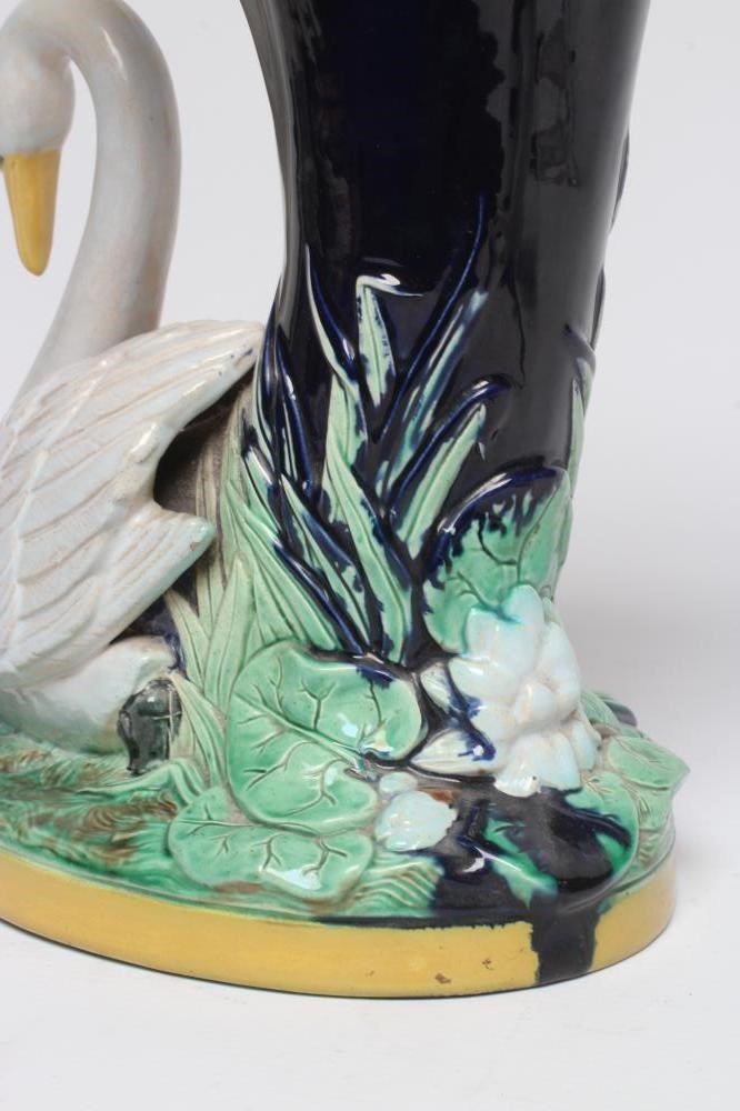 A LATE VICTORIAN JOSEPH HOLDCROFT MAJOLICA VASE modelled as a swan beside a blue glazed cornucopia Image