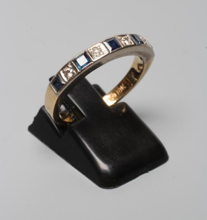 A SAPPHIRE AND DIAMOND HALF HOOP RING, the five square cut sapphires and four round cut brilliant Image