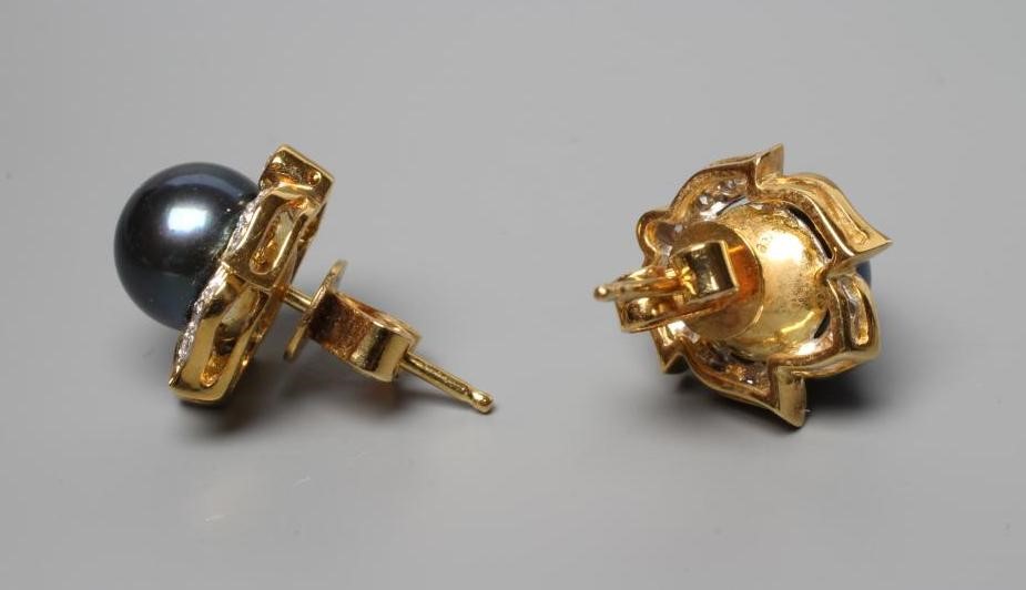 A PAIR OF BLACK CULTURED PEARL AND DIAMOND CLUSTER EAR STUDS set to plain posts and butterflies, Image