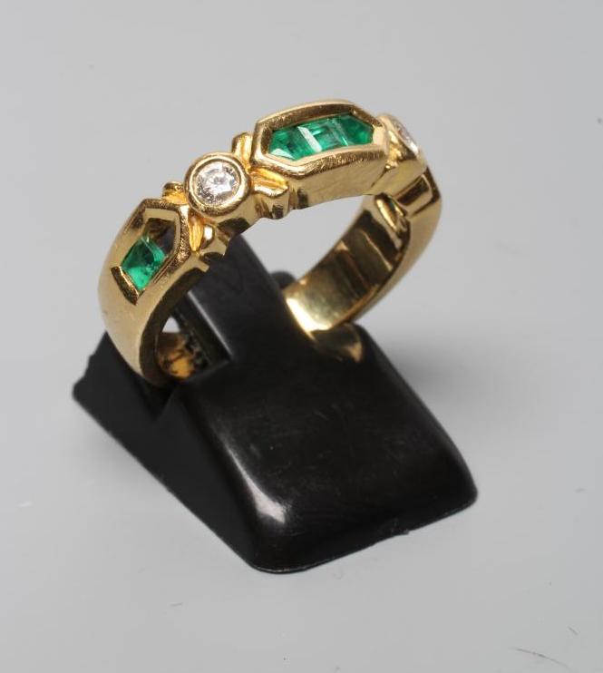 AN EMERALD AND DIAMOND HALF HOOP RING Image