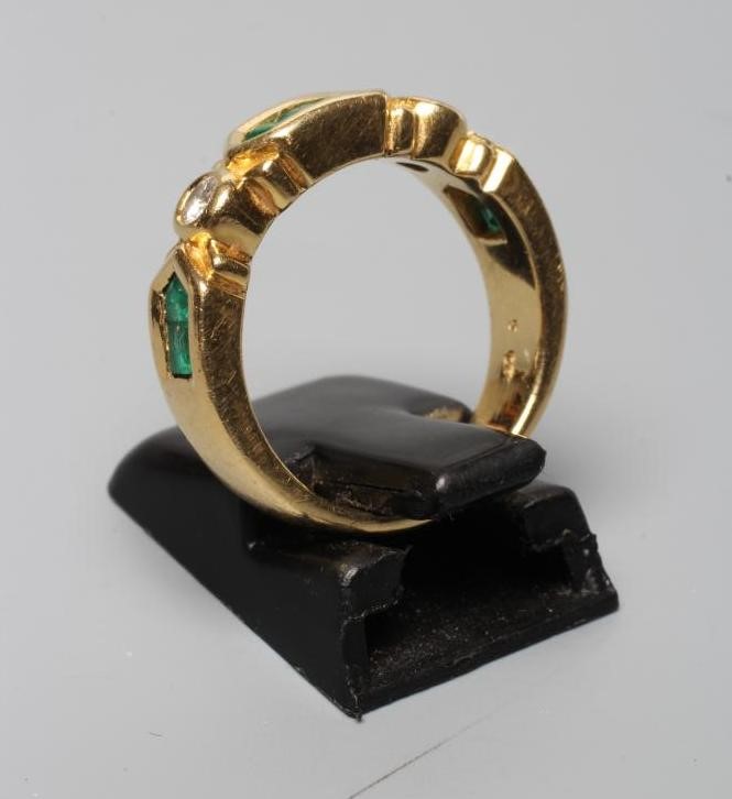 AN EMERALD AND DIAMOND HALF HOOP RING Image