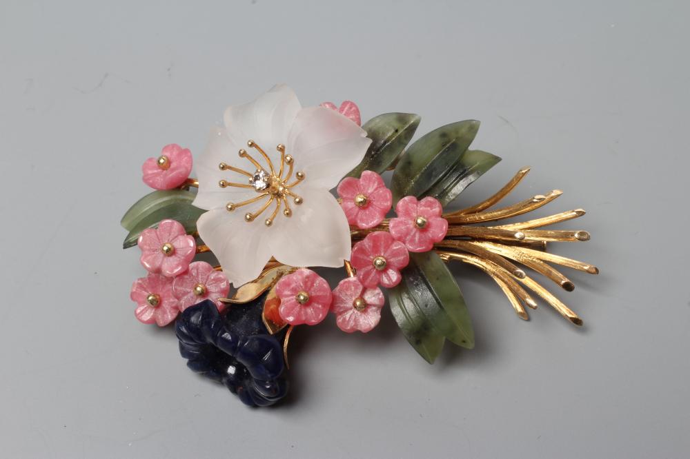 A SPRAY BROOCH with crystal and nephrite flowers and leaves and a diamond stigma, all set to a plain Image