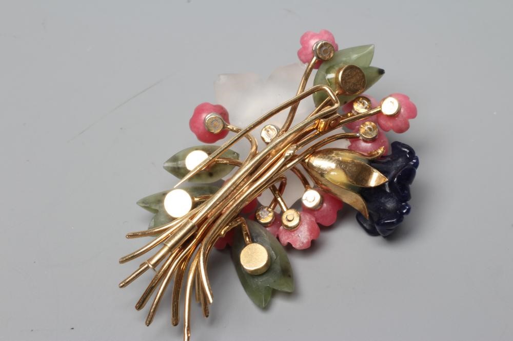 A SPRAY BROOCH with crystal and nephrite flowers and leaves and a diamond stigma, all set to a plain Image
